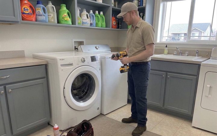 Technician working on a laundry pair in a Bellingham home